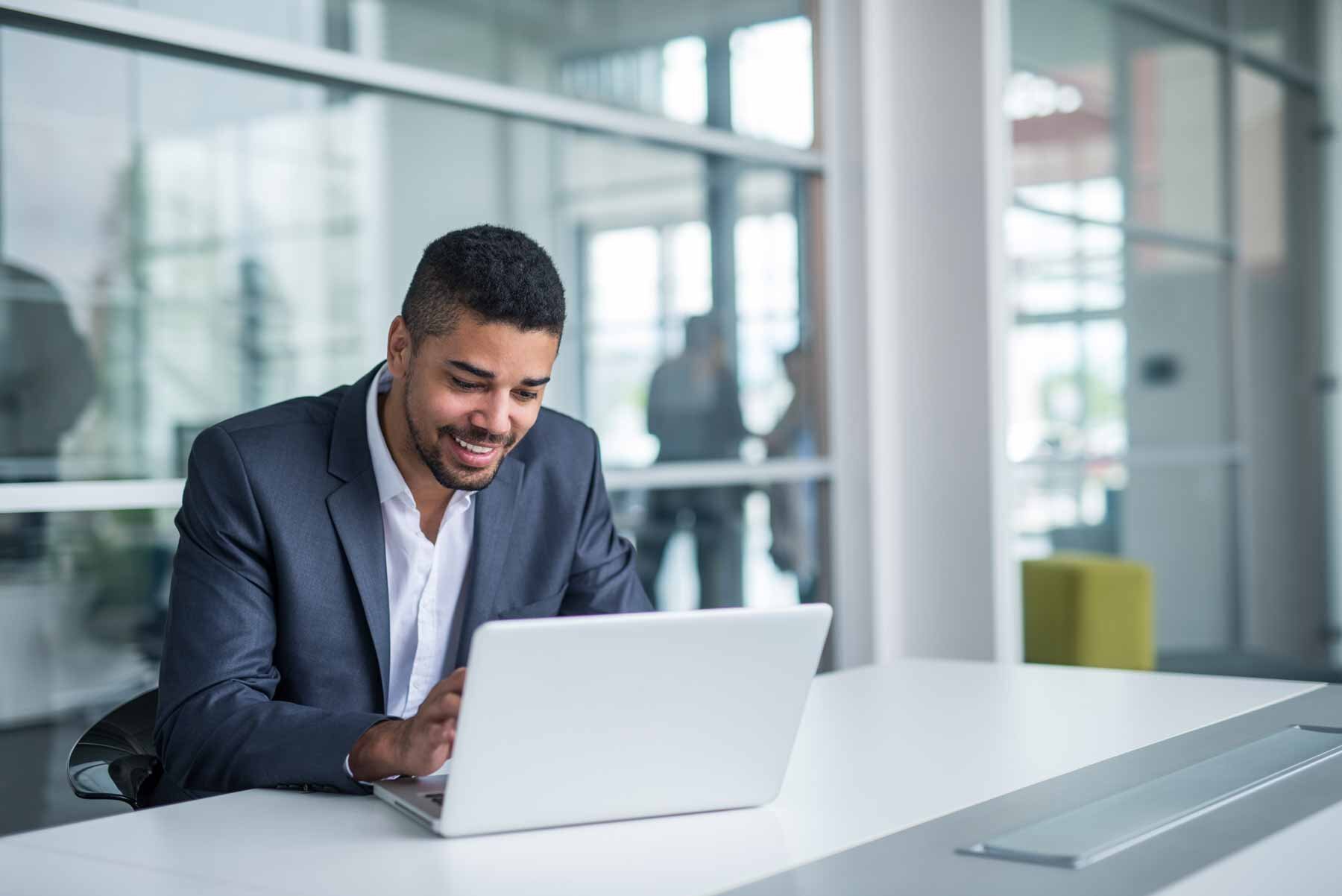 An African-American salesman expertly utilizing HubSpot's sequences feature for efficient outbound sales activities.