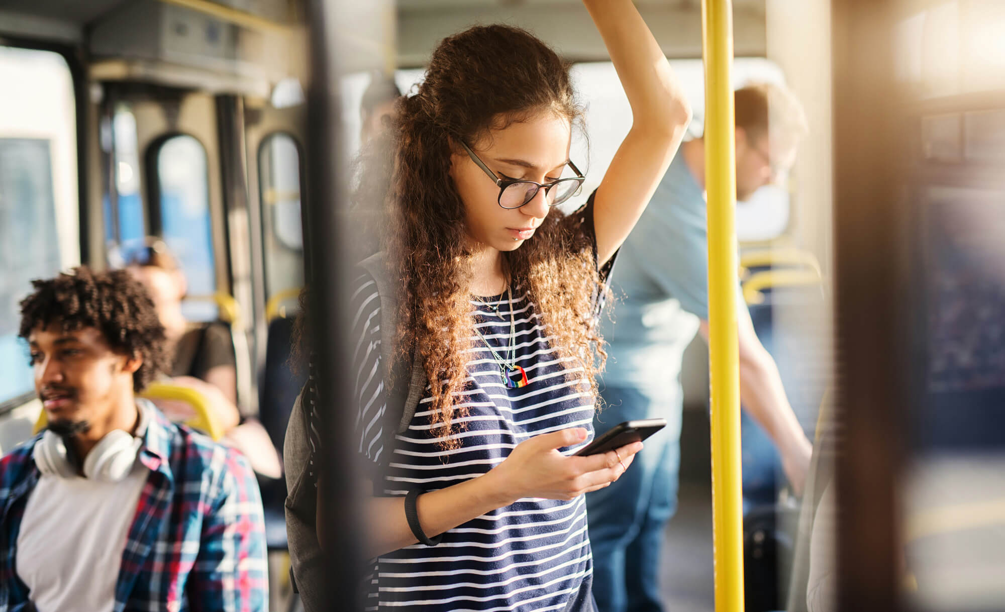 People checking phones in a busy setting, searching across Google and AI tools