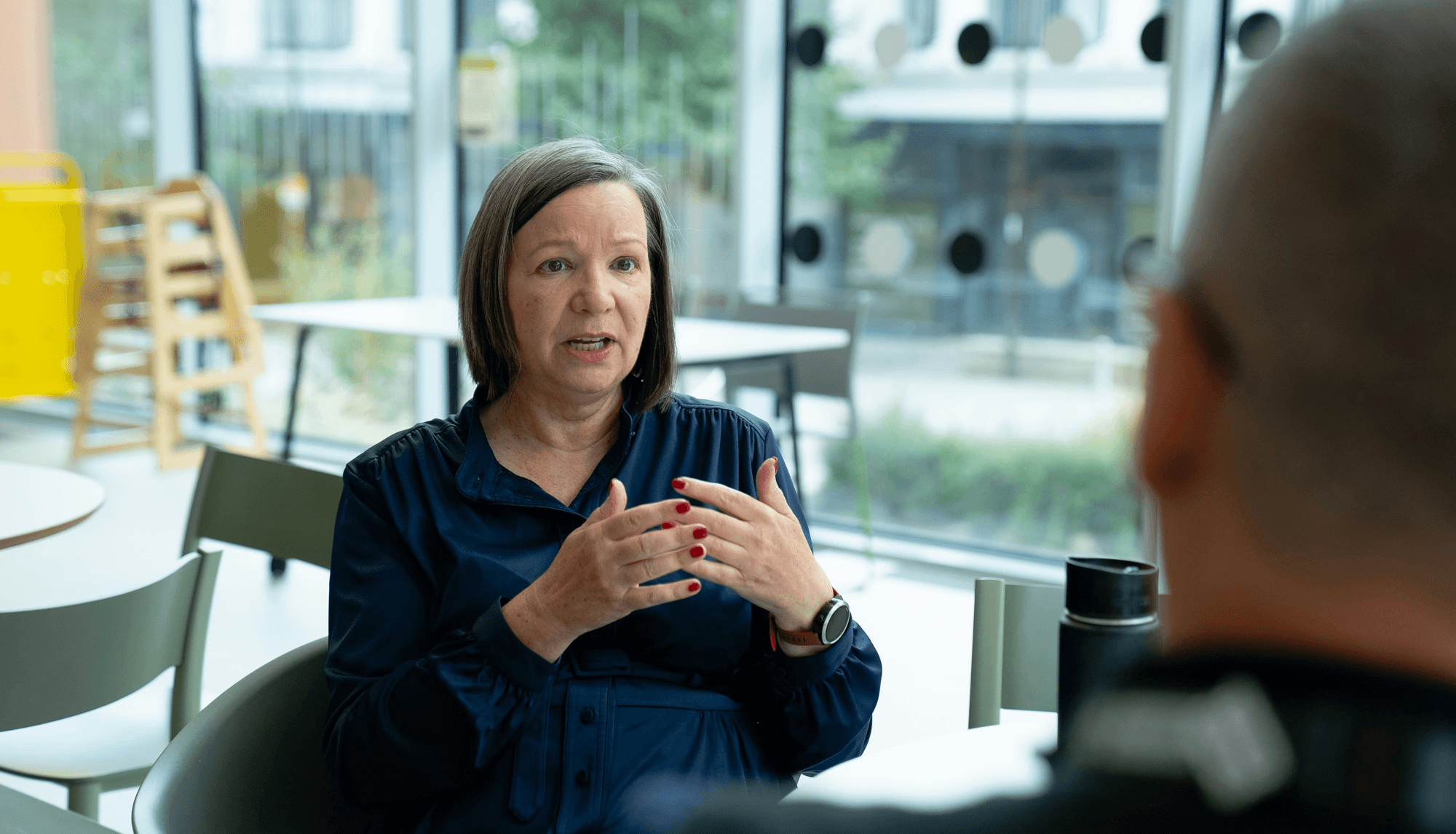 "Founder discussing marketing challenges with a consultant in a modern coworking space