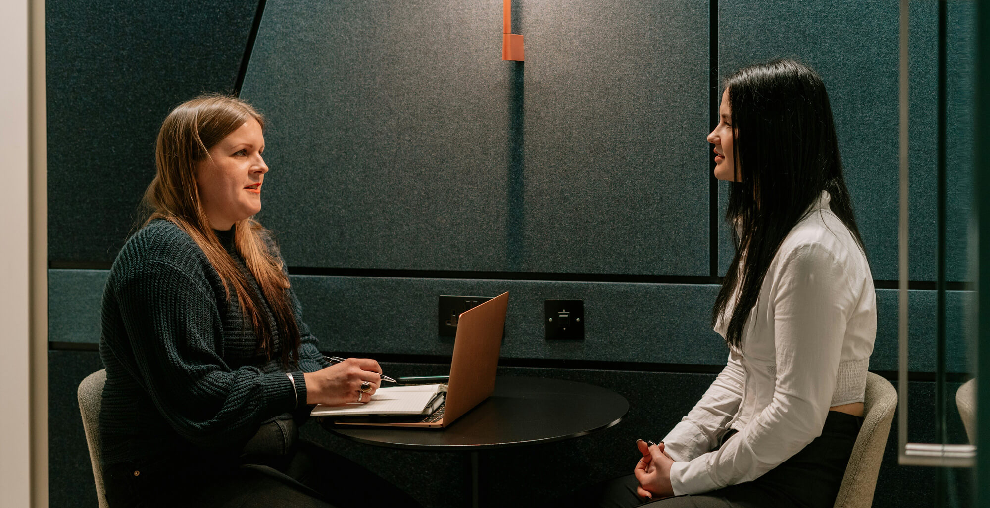 Two marketing professionals discussing AEO vs SEO strategy and visibility budget allocation in a meeting